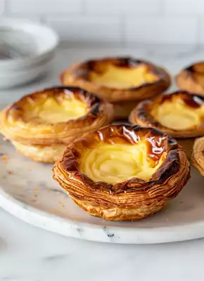 https://recipesblob.oetker.ca/assets/d05e1f667ca34c4a89666664806e793f/290x400/pastel-de-nata-11.webp